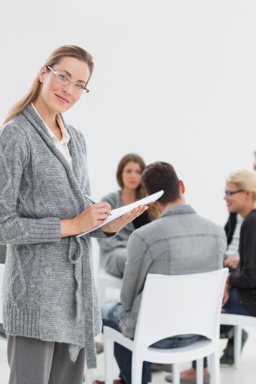 Therapist with group therapy in session Therapist with group therapy in session